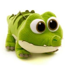 a green stuffed animal with big eyes