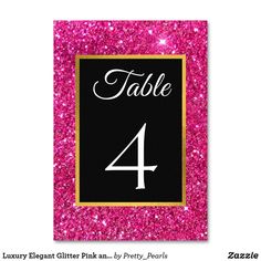 pink glitter table number card with black and gold border