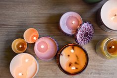 several candles sitting on top of a wooden table