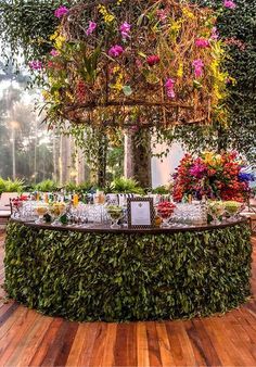 the table is covered with flowers and greenery