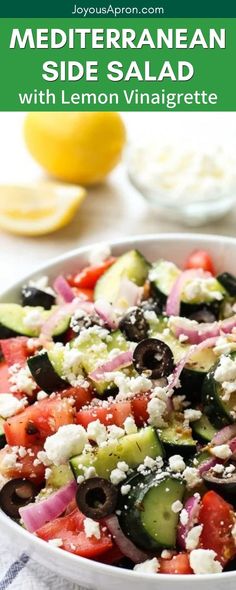 a salad with cucumbers, tomatoes, olives and feta cheese in a white bowl