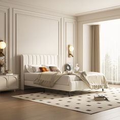 a white bed sitting in a bedroom on top of a hard wood floor next to a window