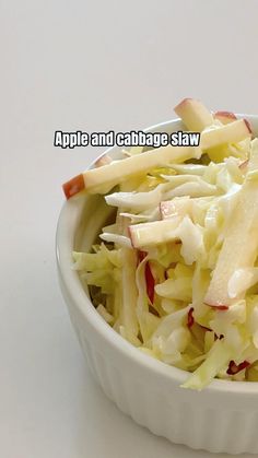 an apple and cabbage slaw in a bowl on a white surface with the caption apples and cabbage slaw