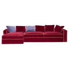 a red sectional couch with blue pillows on the top and bottom, in front of a white background