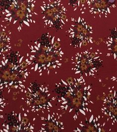 a red and brown floral print fabric with small flowers on it, including one flower in the center