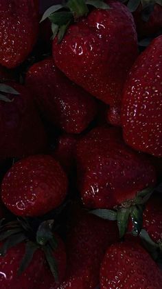 a pile of red strawberries sitting on top of each other