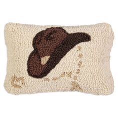 a pillow with a brown hat on it