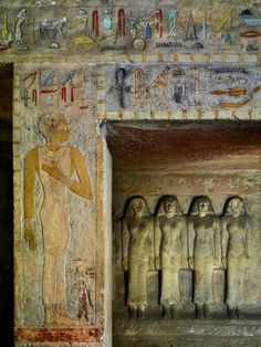 an egyptian temple with statues and paintings on the walls