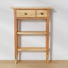 a wooden shelf with two drawers on it