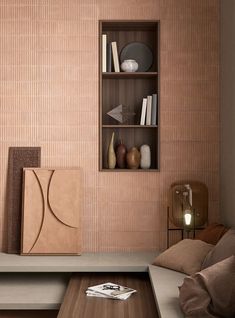 a living room filled with furniture and bookshelves next to a wall mounted shelf