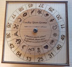 a wooden clock with numbers and zodiac signs on it