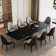 a dining room table with chairs around it and a rug in front of the table