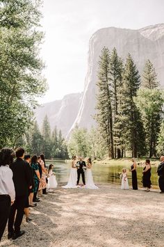 a couple getting married in front of a mountain