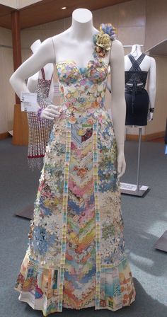 a woman's dress on display in a room full of mannequins