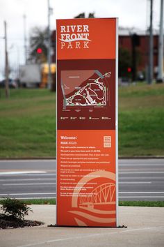 a sign on the side of a road that says river front park with a map