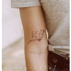 a woman with a tattoo on her arm that says,'girl'in cursive writing