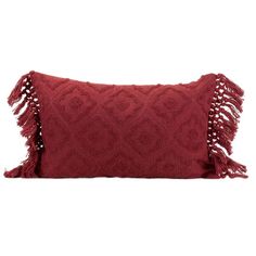 a red pillow with tassels on the front and back, sitting against a white background