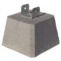 a cement block with two metal brackets on it's end and the top section missing