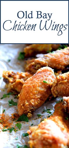 old bay chicken wings with parsley on top and the title overlay reads, old bay chicken wings