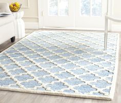 a blue and white rug in a living room