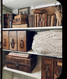 there are many old suitcases and books on the shelves