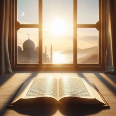 an open book sitting on top of a table in front of a window with the sun shining through it