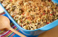 a blue casserole dish filled with rice and vegetables