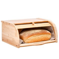 a loaf of bread in a wooden bread box with the door open to show it's inside