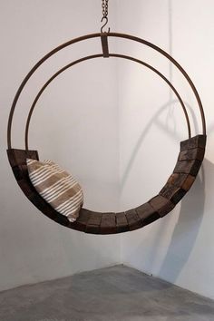 a circular metal object hanging from a chain