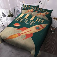 a bed with an image of a rocket ship and the words all the moon printed on it