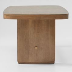 a wooden table with an oval shaped top