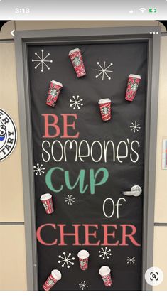 a door decorated with cups and snowflakes that says be someone's cup of cheer