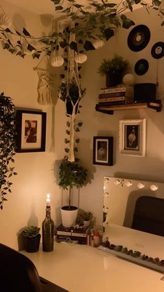 a living room with plants and pictures on the wall