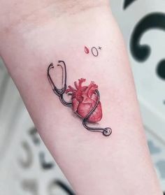 a small heart with a stethoscope tattoo on the left forearm and right arm