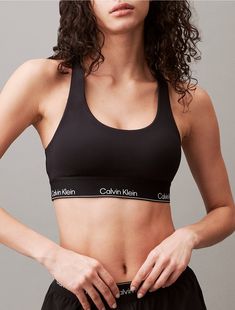 Minimalist with a solid body, this padded sports bra is constructed from moisture-wicking fabric for total comfort and breathability during workouts. Created with a racerback silhouette and a scoop neckline. Designed with an elastic underband detailed with repeating Calvin Klein logos.  Material: 88% Polyester, 12% Elastane. Logos, Calvin Klein Boxers For Women, Boxers For Women Shorts, Boxers For Women, Calvin Klein Boxers, Calvin Klein Outfits, Calvin Klien, Calvin Klein Bra, Padded Sports Bra