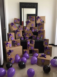 purple and black balloons are on the floor next to boxes