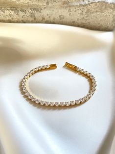 Stunning shiny zirconia 18k gold plated Stainless Steel Tennis bracelet. Comfortable to put on with a clasp conector. Ideal piece for your bracelet stack. You can easily style it with every outfit day or evening, casual or occasional. Perfect piece to elevate your look! P A C K A G I N G All items will be sent in a beautiful soft Velvet pouch with a drawstring, ready for gifting or to keep for yourself.  Gift Card note with the name and a greeting, of your any special occasion, could be added fr Trendy Gold Cubic Zirconia Tennis Bracelet, Gold Tarnish Resistant Cubic Zirconia Tennis Bracelet, Gold Tarnish-resistant Cubic Zirconia Tennis Bracelet, Bracelet Tennis, Style Gift, Beautiful Gift Boxes, Tennis Bracelet, Bracelet Stack, Minimalist Style