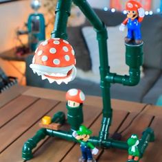 mario and luigi figurines on a table in front of a light up mushroom