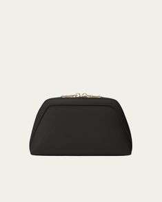 a black clutch bag with gold hardwares on the front and side, sitting against a white background