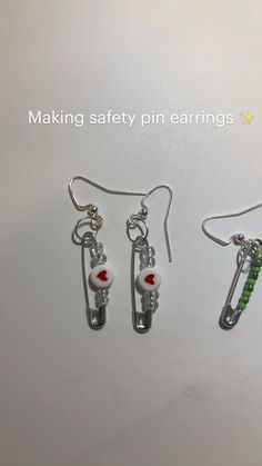 three pairs of earrings are shown on a white surface with the words making safety pin earings