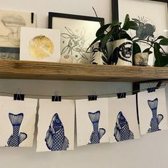 blue and white artwork hanging on a shelf