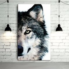 a painting of a wolf is hanging on the wall next to two lamps and a brick wall