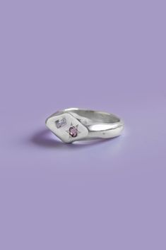 Add a pop of color to your daily style with this unique diamond-shaped signet ring. Handcrafted in sterling silver, it features a beautiful Purple and Pink Sapphire. Select your size from the drop-down to get the perfect fit.If you are unsure of your ring size refer to our size guide. Please select your ring size carefully, and reach out if you have any questions. Details925 Sterling SilverHandcrafted in our studio1x Round-cut pink Sapphire and 1x baguette-cut purple Sapphire Beauty In Imperfection, Purple Ring, Silver Ring Designs, Silver Signet Ring, Purple Sapphire, Funky Jewelry, Bling Rings, Pink Ring, Daily Style