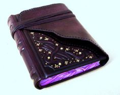 a purple leather wallet with gold stars on it