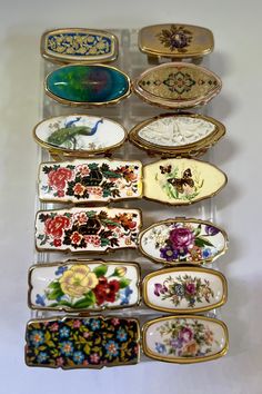 a collection of porcelain plates and trays with flowers painted on them, all in different colors