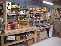 a workbench filled with lots of tools and other items on shelves in a garage