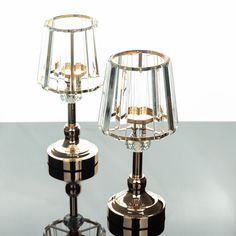 two lamps sitting on top of a table next to each other