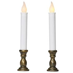 two white candles sitting next to each other