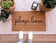 a welcome mat with the words welcome to our nest on it next to potted plants