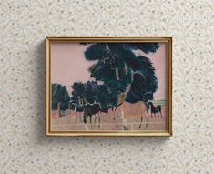 a painting hanging on the wall next to a tree